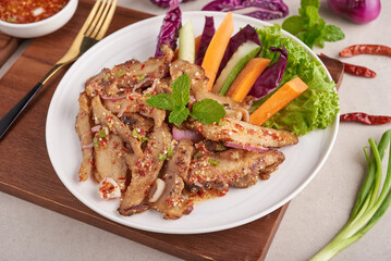 Grilled pork salad thai food with herbs and spices ingredients, tradition northeast food delicious with fresh vegetables, Hot and spicy slice grilled pork menu asian food. Grilled pork with spicy dip.