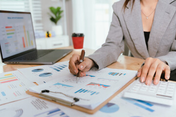 Businessman analyzing financial charts and documents at office desk, focused on planning, investment, accounting, growth strategy, and corporate success