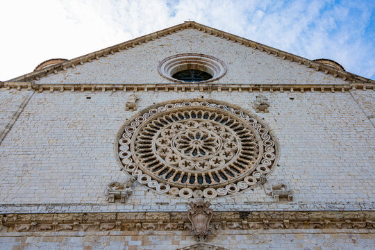 Tourists walk near the Basilica of Saint Francis in Assisi, Italy, a UNESCO World Heritage Site and a major pilgrimage destination