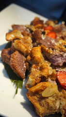 Indulge in Umm Ali! Layers of pastry soaked in sweet milk, topped with nuts. A rich, comforting treat