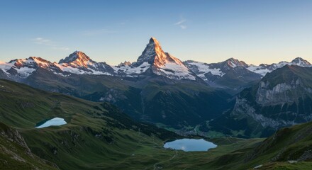 Fototapeta premium Majestic sunrise illuminates snow-capped peaks and serene alpine lakes nestled within verdant valleys