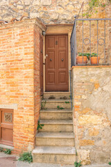 Fototapeta premium Quaint alleyway with rustic stone buildings in the historic village of Pienza, Tuscany, Italy