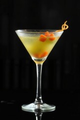 Golden Hour Cocktail: A sophisticated martini glass showcases a vibrant, expertly crafted cocktail, garnished with citrus zest, creating a visually stunning drink