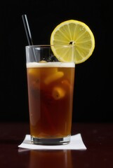 Refreshing Iced Tea with Lemon: A refreshing glass of iced tea, garnished with a lemon slice, rests invitingly on a coaster, perfect for a hot day.