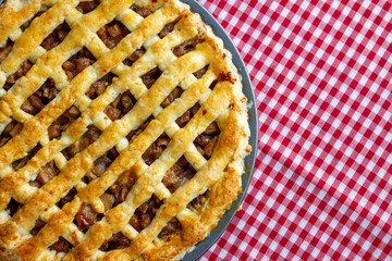 pie apple homemade in tray on tablecloth red-white scotch pattern