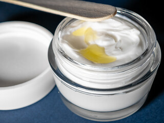 Mixing face cream, homemade ointment with oils close up