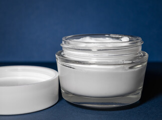 Care, moisturizing cream with hyaluronic acid and peptides in a glass jar