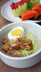 Deconstructed Soto Ayam: Rich chicken, sprouts, and egg, showcasing fresh ingredients. Ideal for Indonesian cuisine, healthy eating, and food prep visuals