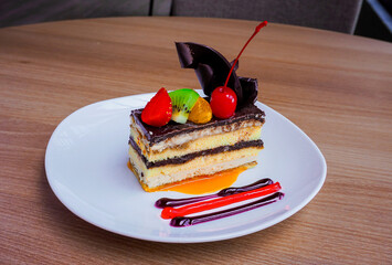 Delicious chocolate cake. Fresh fruit topping, pure delight. Elevate your project with this irresistible treat.