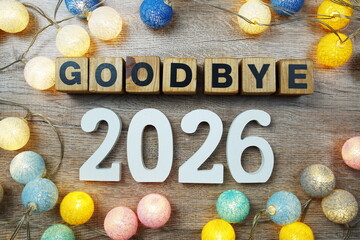 Goodbye 2026 years number with LED cotton balls decoration top view on wooden background
