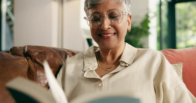 Senior, happy woman and reading with book on sofa for funny story, comedy or humor at home. Mature, female person and laughing with smile or novel for joke, comic or retirement on couch at house