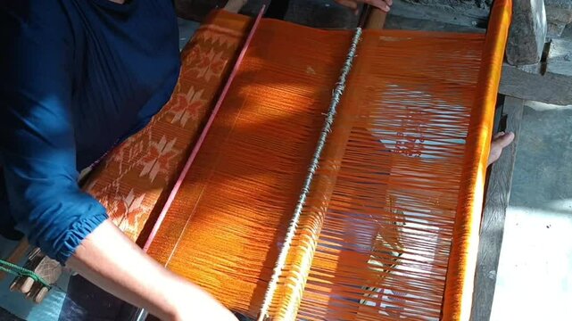 The process of making traditional handwoven fabric from Lombok, Indonesia, is done manually without using machines, employing tools made of wood.

