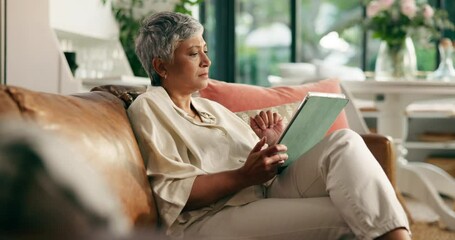 Tablet, relax and mature woman on sofa in home reading online blog, newsletter or ebook. Digital technology, calm and female person on couch in living room browsing on social media app in house. - Powered by Adobe