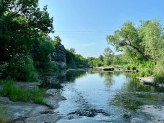 A breathtaking view of the Buca Canyon in Ukraine, a winding river flowing between high rocky banks...