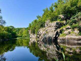 A breathtaking view of the Buca Canyon in Ukraine, a winding river flowing between high rocky banks...