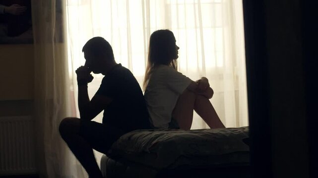 A couple sits together in silence, emotionally distant and disconnected. Despite physical closeness, tension and isolation dominate. A visual concept of relationship crisis and mental health.