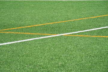 Obraz premium Vibrant green turf with crisp white and orange lines marking the field