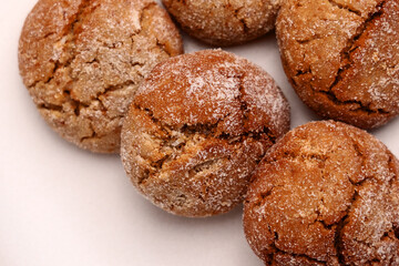 Baked ginger snap cookies with cracked crumbly texture on ceramic plate. Macro shot. 