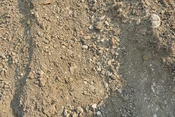 大小の石が混ざった建築用の砂利。乾いた地面の背景テクスチャー