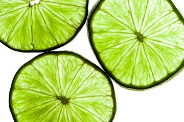 Close-up of a vibrant green lime slice backlit to reveal detailed veins and texture. A fresh, zesty...