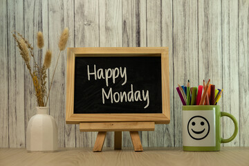 A cozy desk setting featuring a 'Happy Monday' chalkboard paired with vibrant stationery and natural decor, perfect for inspiring positivity and creativity at the start of the week.
