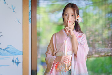 Pretty young Asian Japanese woman in Traditional Yukata Dress. A young Asian girl is wearing a...