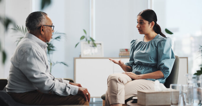Anxiety, talking and psychology with old man on sofa for counseling, mental health and discussion. Therapy session, trauma rehabilitation and healing with person in clinic for support and progress