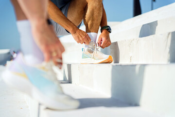 Lacing up Athletic Shoes on Bright White Steps During a Sunny Afternoon in a Vibrant Urban Park...