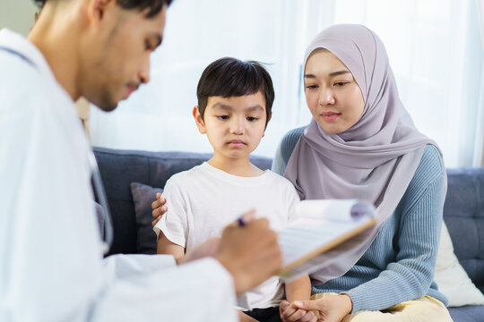 Asian muslim woman take her son the see a doctor in hospital. - Powered by Adobe