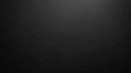 Close-up image of black textured leather surface with fine grain patterns and subtle reflective highlights.