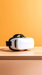 White Virtual Reality Headset on Wooden Table Against Orange Background