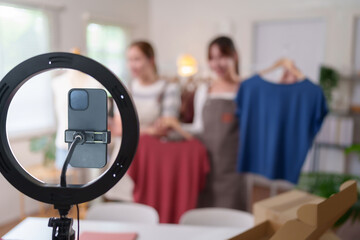 Asian Women Fashion Vlogging with Ring Light and Smartphone for Online Clothing Store Product Display and Social Media Content Creation