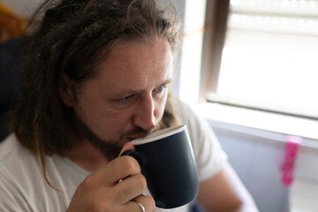 Freelancer drinking coffee while working from home office