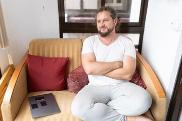 Freelancer relaxing on sofa with laptop at home office