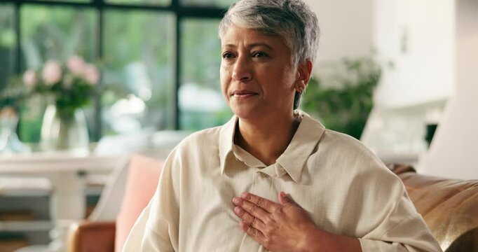 Home, chest pain and senior woman with heart attack, health risk or angina with medical emergency. Retirement, heartburn and sick person with cardiovascular disease, cardiac arrest and hypertension