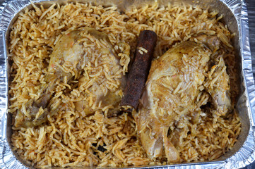 chicken and rice cooked in a pressure cooker with a mix of special spice, Yellow Basmati rice, Basmati is a variety of long, slender-grained aromatic rice which originates from the India