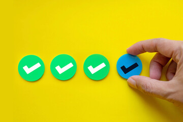 Hand placing checkmark in row; Concept of task progress and checklist in Project management 