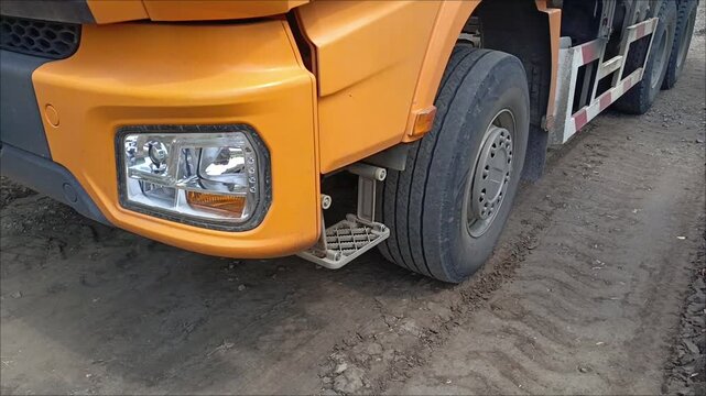 Truck wheels on the ground in close-up. Tire tracks of heavy machinery on the ground at the construction site.
