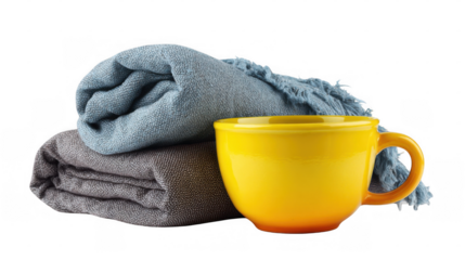 Two folded blankets, one gray and one light blue, sit next to a large, bright yellow mug, all arranged on a transparent background, creating a cozy and inviting scene