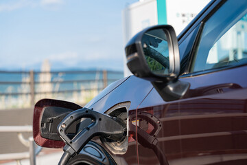Electric vehicle charging stations along travel routes, powered by clean energy technologies, offering a sustainable and efficient solution for on-the-go battery recharging.