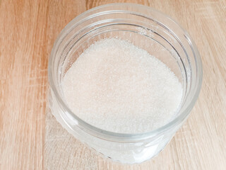 Sugar in a jar. Sugar consumption, white granulated sugar. Calories of sugar.