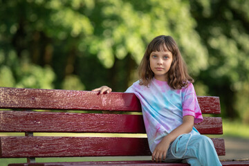 Obraz premium Portrait of young beautiful long-haired girl outdoors in summer.