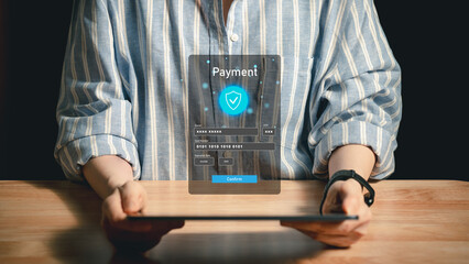 Person using tablet with holographic secure payment form showing credit card details and confirm button representing online purchase safety