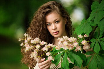 Fototapeta premium Portrait of beautiful young girl in park in spring