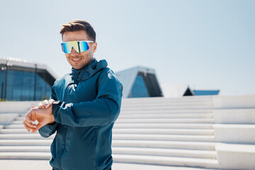 Urban Athlete Prepares for a Run in Modern Cityscape Under Bright Sunlight, Showcasing Sporty Gear...