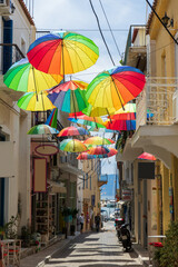 Colorful Umbrellas Adorning Aegina Greece Alley with Quaint Shops