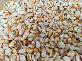 Abstract peanut background. Peanut texture with skin removed in beige brown. Peanut background. Roasted peanuts.