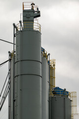 Industrial silos reaching for the cloudy sky: storage and processing powerhouse
