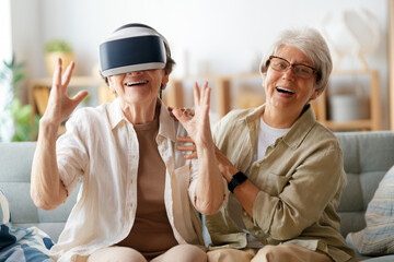 women playing console games wearing vr goggles