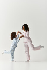 Dreams take flight together a mother and daughter dance in pyjamas